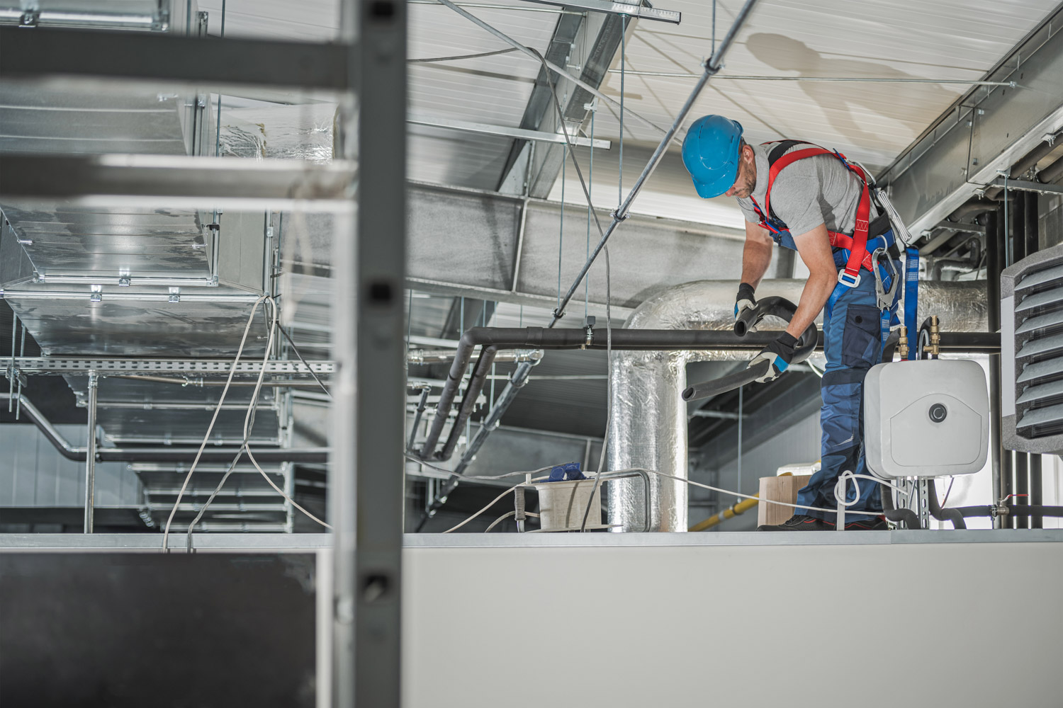 HVAC Technician Finishing System Assembly Inside Commercial Buil